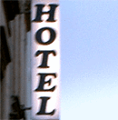 The picture shows a neon sign with the word "Hotel".